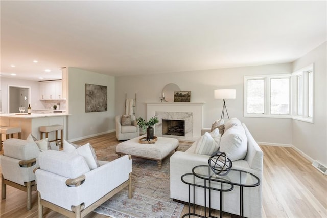 5308 Foster St, Overland Park, KS 66202 - living room featuring baseboards, light wood-style floors, a fireplace, and recessed lighting