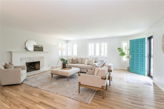 5308 Foster St, Overland Park, KS 66202 - living room with light wood-style flooring, a fireplace, and baseboards