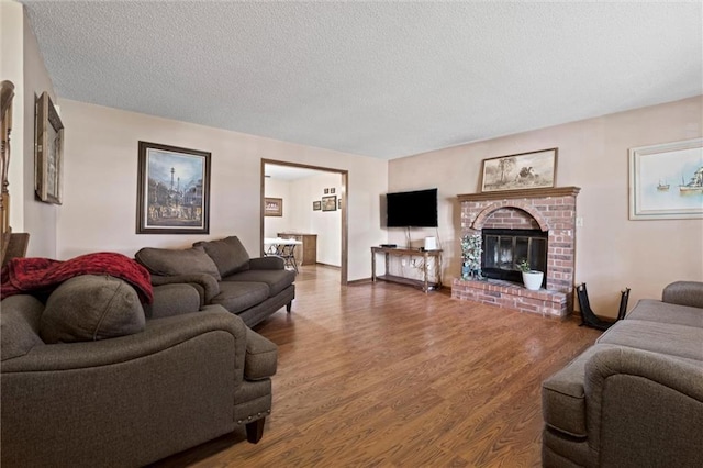 446 Hithergreen Dr, Lansing, KS 66043 - living area with wood finished floors, a textured ceiling, and a fireplace