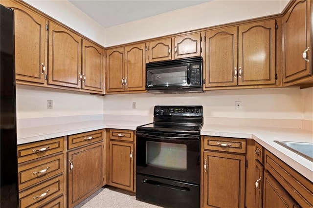 446 Hithergreen Dr, Lansing, KS 66043 - kitchen featuring black appliances, brown cabinets, and light countertops