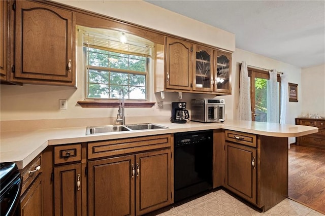 446 Hithergreen Dr, Lansing, KS 66043 - kitchen featuring dishwasher, a peninsula, range, and light countertops
