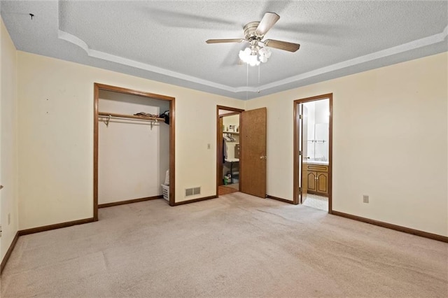 446 Hithergreen Dr, Lansing, KS 66043 - unfurnished bedroom with a raised ceiling, a textured ceiling, light colored carpet, ensuite bathroom, and a closet