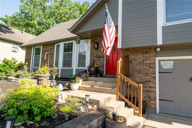 1504 SW 9th St, Lees Summit, MO 64081 - view of exterior entry featuring brick siding and a garage