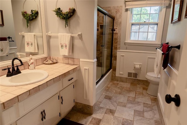 1504 SW 9th St, Lees Summit, MO 64081 - full bath featuring vanity, stone finish flooring, and combined bath / shower with glass door