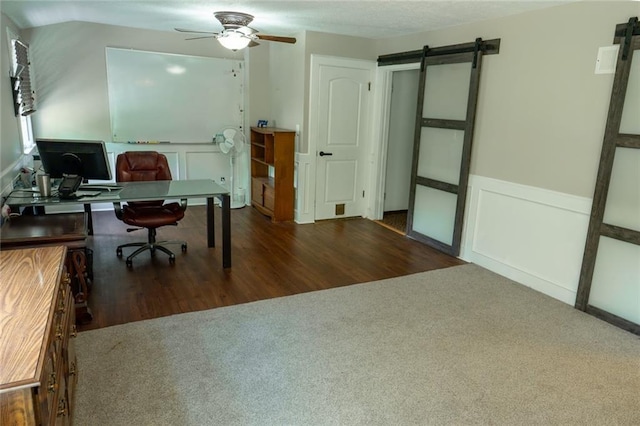 1504 SW 9th St, Lees Summit, MO 64081 - office space with a barn door, ceiling fan, carpet flooring, a decorative wall, and wainscoting