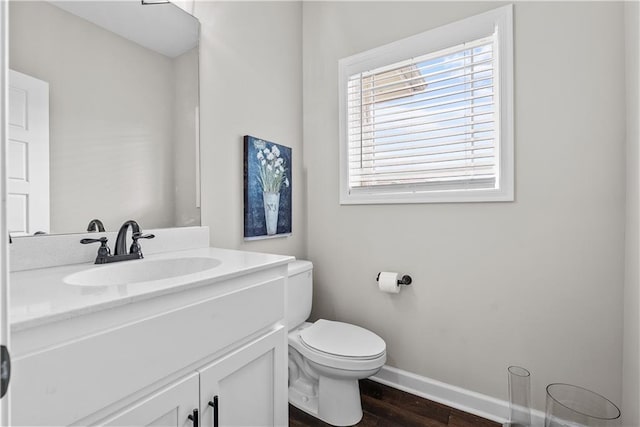 19714 W 197th Ct, Spring Hill, KS 66083 - half bathroom featuring baseboards, vanity, wood finished floors, and toilet