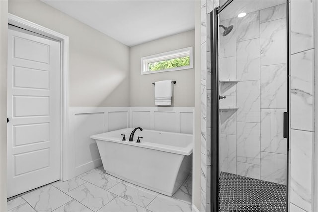 19714 W 197th Ct, Spring Hill, KS 66083 - full bath with marble finish flooring, a shower stall, a soaking tub, a wainscoted wall, and a decorative wall