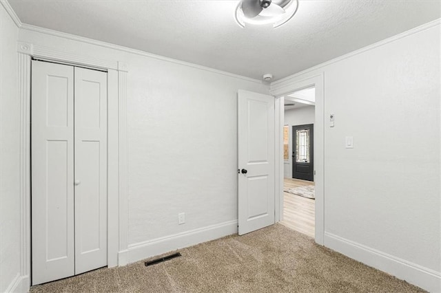 1115 S Leslie St, Independence, MO 64050 - unfurnished bedroom with crown molding, carpet flooring, and a closet