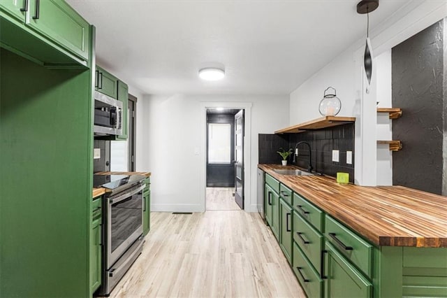 1115 S Leslie St, Independence, MO 64050 - kitchen featuring green cabinets, butcher block countertops, open shelves, and stainless steel appliances