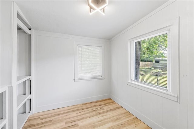 1115 S Leslie St, Independence, MO 64050 - spare room featuring light wood-type flooring and a decorative wall