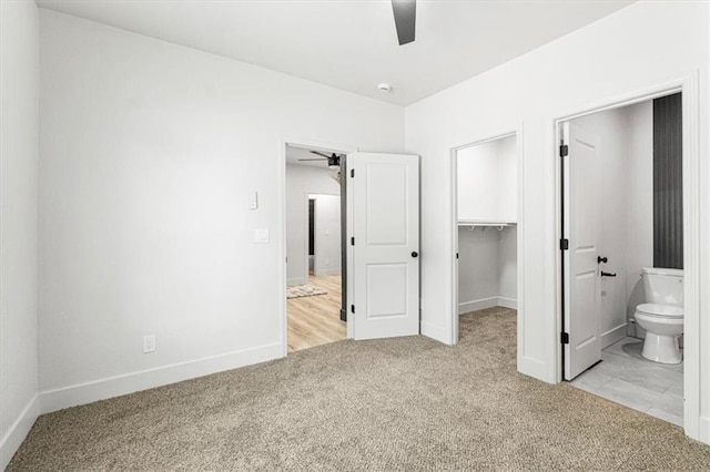 1115 S Leslie St, Independence, MO 64050 - unfurnished bedroom featuring carpet flooring, a spacious closet, ensuite bath, a closet, and a ceiling fan