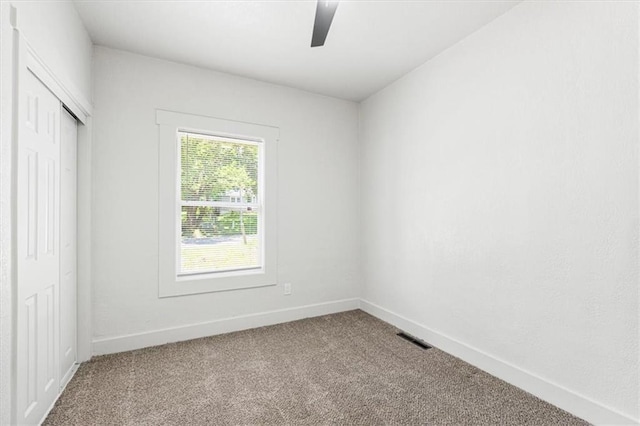 1115 S Leslie St, Independence, MO 64050 - unfurnished bedroom with carpet, a closet, and a ceiling fan