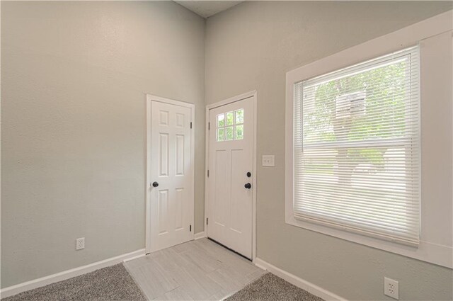 11300 Greenwood Rd, Kansas City, MO 64134 - foyer entrance featuring light carpet and baseboards