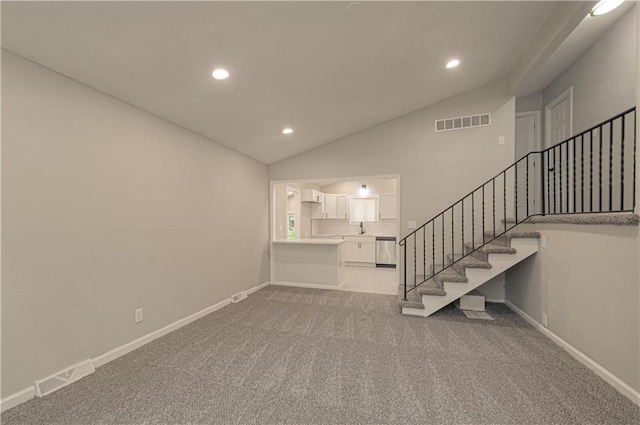 11300 Greenwood Rd, Kansas City, MO 64134 - unfurnished living room with recessed lighting, vaulted ceiling, light colored carpet, stairs, and baseboards