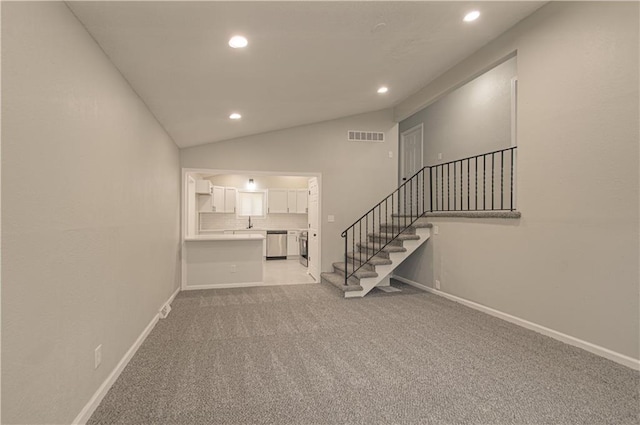 11300 Greenwood Rd, Kansas City, MO 64134 - unfurnished living room with recessed lighting, stairway, light colored carpet, baseboards, and lofted ceiling