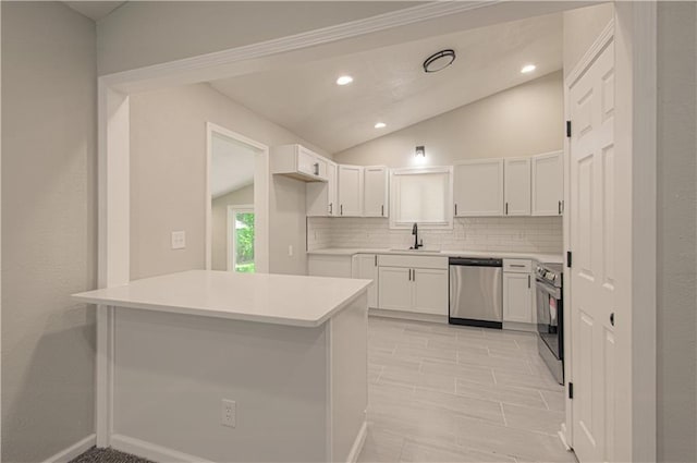 11300 Greenwood Rd, Kansas City, MO 64134 - kitchen featuring appliances with stainless steel finishes, a sink, vaulted ceiling, decorative backsplash, and white cabinets