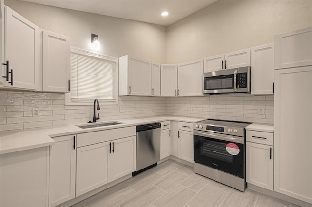 11300 Greenwood Rd, Kansas City, MO 64134 - kitchen with stainless steel appliances, a sink, backsplash, light countertops, and recessed lighting