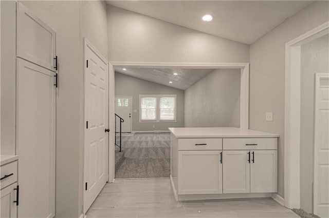 11300 Greenwood Rd, Kansas City, MO 64134 - bathroom featuring lofted ceiling, recessed lighting, wood finished floors, baseboards, and vanity