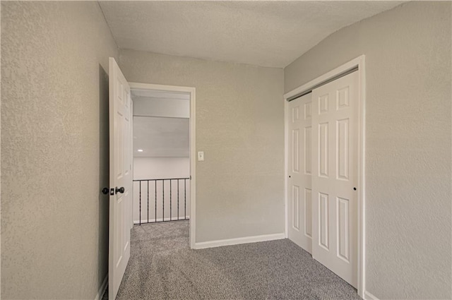 11300 Greenwood Rd, Kansas City, MO 64134 - hall with a textured wall, carpet, a textured ceiling, and baseboards