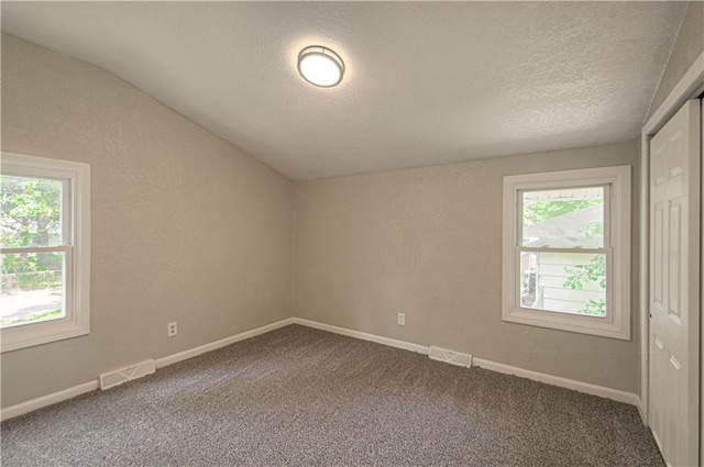 11300 Greenwood Rd, Kansas City, MO 64134 - unfurnished room featuring carpet floors, lofted ceiling, a textured ceiling, and baseboards