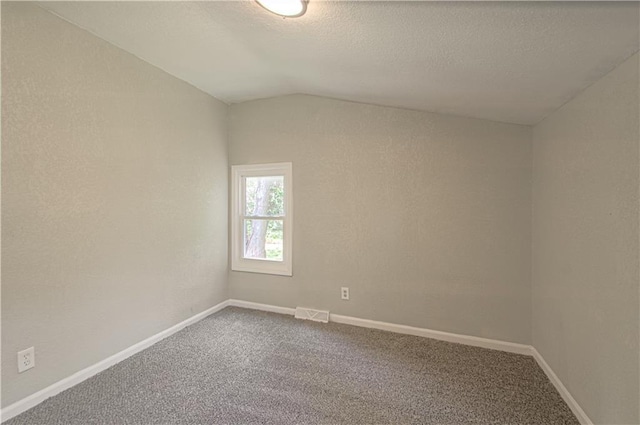 11300 Greenwood Rd, Kansas City, MO 64134 - carpeted empty room with lofted ceiling, a textured ceiling, and baseboards