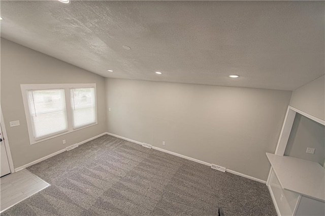 11300 Greenwood Rd, Kansas City, MO 64134 - carpeted empty room featuring a textured ceiling, lofted ceiling, recessed lighting, and baseboards