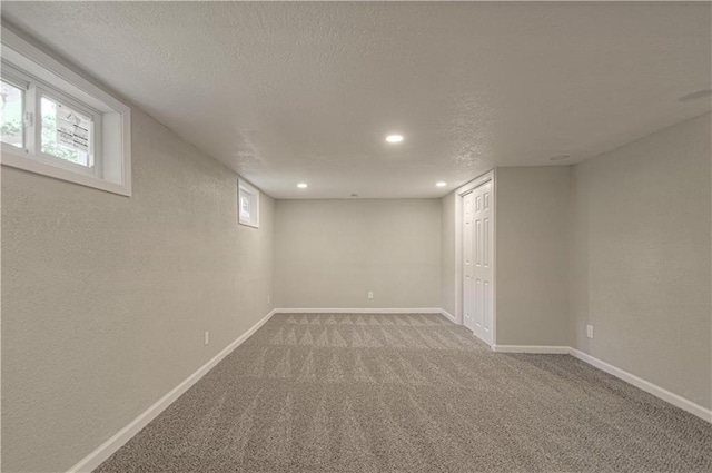 11300 Greenwood Rd, Kansas City, MO 64134 - basement featuring a textured ceiling, carpet flooring, baseboards, and recessed lighting