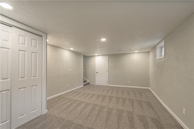 11300 Greenwood Rd, Kansas City, MO 64134 - finished basement with carpet flooring, stairway, a textured ceiling, baseboards, and recessed lighting