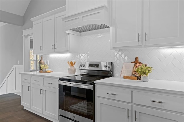 19433 W 114th Ter, Olathe, KS 66061 - kitchen with stainless steel electric range oven, light countertops, custom exhaust hood, white cabinets, and vaulted ceiling