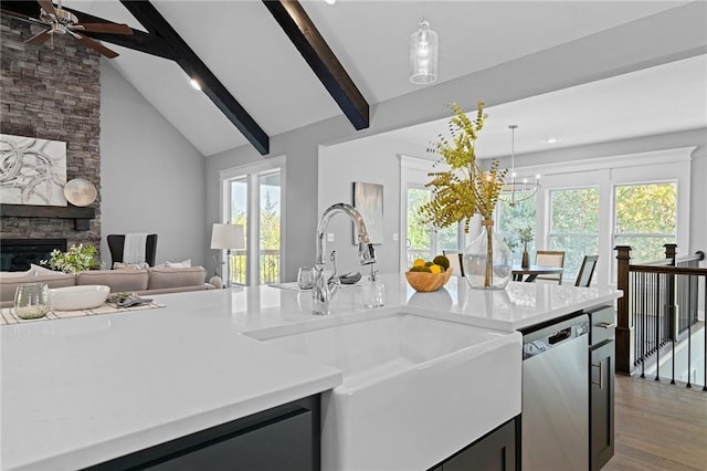 19433 W 114th Ter, Olathe, KS 66061 - kitchen with stainless steel dishwasher, a sink, beamed ceiling, open floor plan, and decorative light fixtures