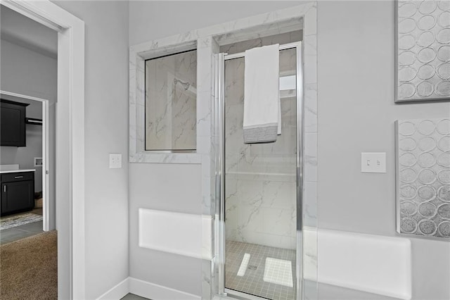 19433 W 114th Ter, Olathe, KS 66061 - full bathroom featuring a marble finish shower, baseboards, and vanity