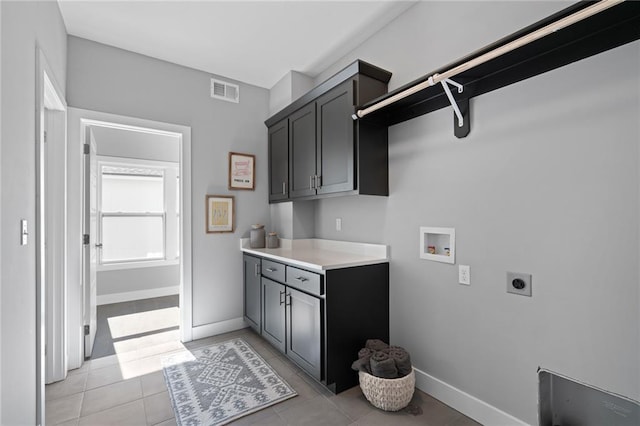 19433 W 114th Ter, Olathe, KS 66061 - laundry room featuring hookup for an electric dryer, cabinet space, hookup for a washing machine, light tile patterned floors, and baseboards