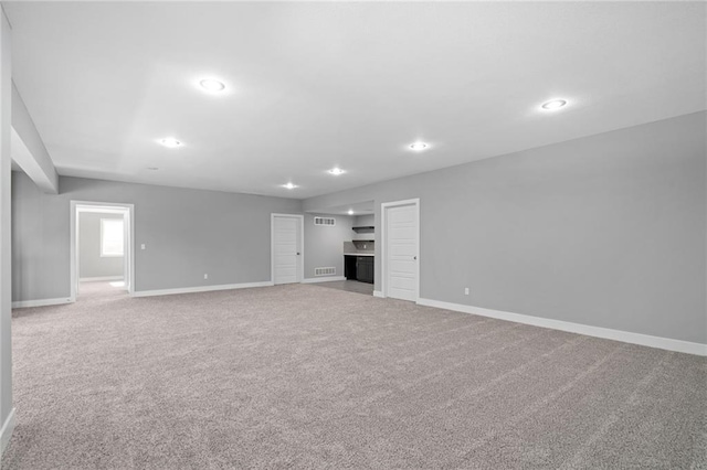 19433 W 114th Ter, Olathe, KS 66061 - unfurnished living room with baseboards, carpet flooring, and recessed lighting