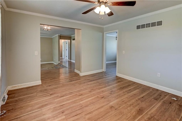 739 SW 700th Rd, Holden, MO 64040 - unfurnished room featuring crown molding, a ceiling fan, light wood-type flooring, baseboards, and a chandelier