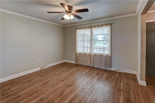739 SW 700th Rd, Holden, MO 64040 - spare room featuring wood finished floors, a ceiling fan, baseboards, ornamental molding, and a textured ceiling