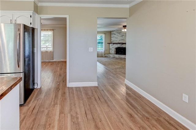 739 SW 700th Rd, Holden, MO 64040 - kitchen with freestanding refrigerator, white cabinets, ornamental molding, baseboards, and ceiling fan