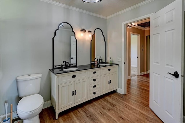 739 SW 700th Rd, Holden, MO 64040 - full bath featuring ornamental molding, double vanity, toilet, wood finished floors, and baseboards