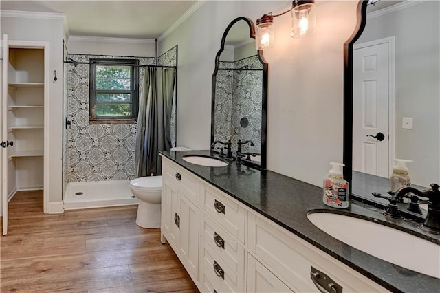 739 SW 700th Rd, Holden, MO 64040 - full bathroom with wood finished floors, tiled shower, double vanity, toilet, and ornamental molding