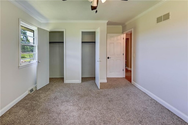 739 SW 700th Rd, Holden, MO 64040 - unfurnished bedroom featuring two closets, carpet, crown molding, ceiling fan, and baseboards