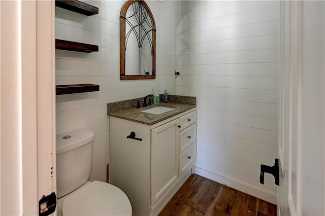 739 SW 700th Rd, Holden, MO 64040 - half bathroom with vanity, wood finished floors, and toilet