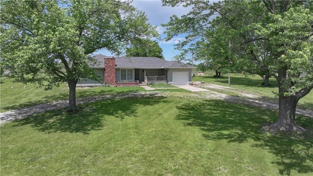 739 SW 700th Rd, Holden, MO 64040 - view of front of home featuring a garage, driveway, a front lawn, and a chimney