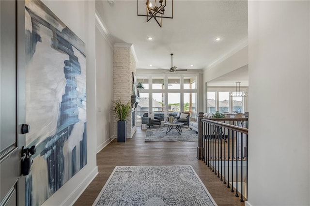 19477 W 114th Ter, Olathe, KS 66061 - hall with ornamental molding, a chandelier, wood finished floors, recessed lighting, and an upstairs landing