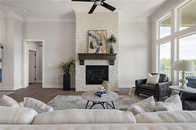 19477 W 114th Ter, Olathe, KS 66061 - living area featuring ornamental molding, a ceiling fan, a stone fireplace, and wood finished floors