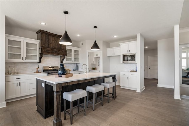 19477 W 114th Ter, Olathe, KS 66061 - kitchen featuring stainless steel appliances, backsplash, wood finished floors, white cabinets, and light countertops