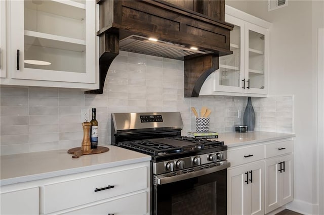 19477 W 114th Ter, Olathe, KS 66061 - kitchen featuring stainless steel range with gas stovetop, exhaust hood, light countertops, and white cabinetry