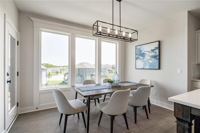 19477 W 114th Ter, Olathe, KS 66061 - dining space featuring a chandelier, wood finished floors, and plenty of natural light