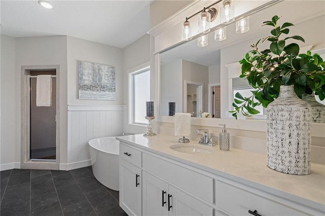 19477 W 114th Ter, Olathe, KS 66061 - bathroom with vanity, wainscoting, a stall shower, a soaking tub, and tile patterned floors