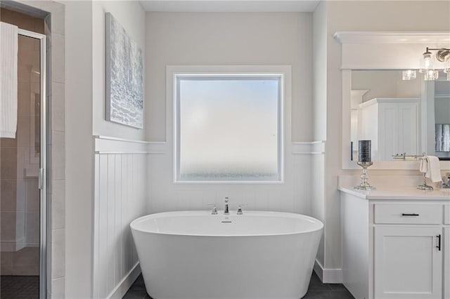19477 W 114th Ter, Olathe, KS 66061 - bathroom with a soaking tub, a stall shower, vanity, and wainscoting