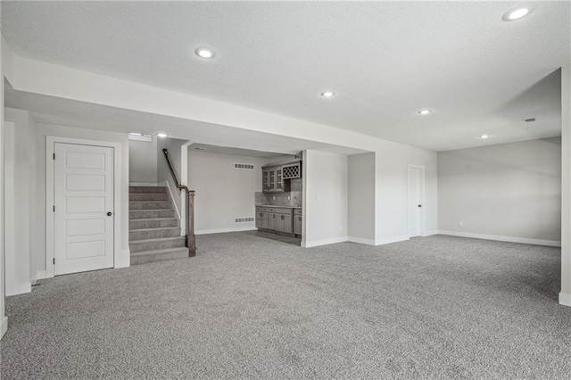 19477 W 114th Ter, Olathe, KS 66061 - finished below grade area with carpet flooring, stairway, recessed lighting, and bar area