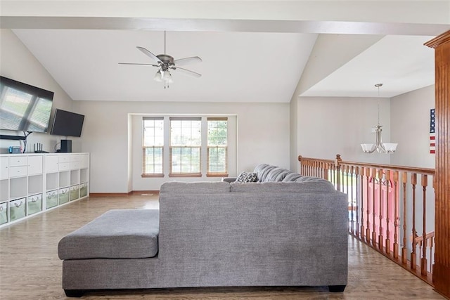 601 W 3rd Ter, Wellsville, KS 66092 - living area featuring vaulted ceiling, plenty of natural light, a chandelier, wood finished floors, and ceiling fan